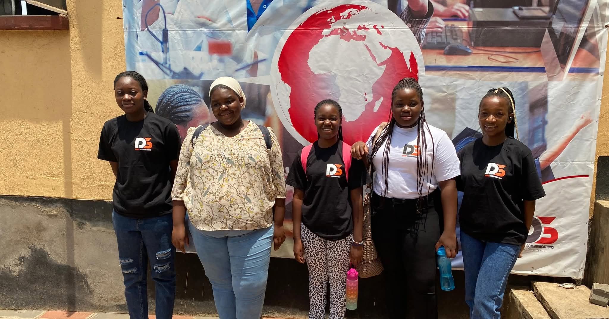 Discom-branded group standing in front of a backdrop